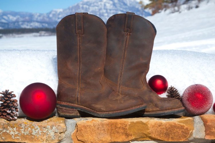 cowboy boots in snow and Christmas