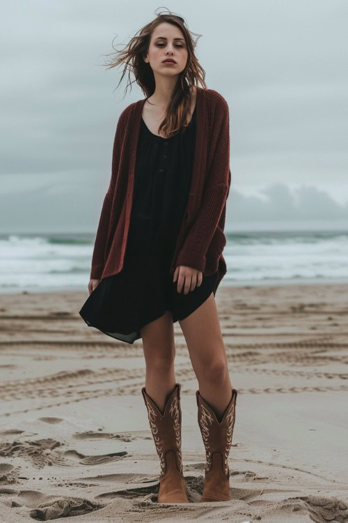a woman wears a burgundy cardigan, a black dress with brown cowboy boots