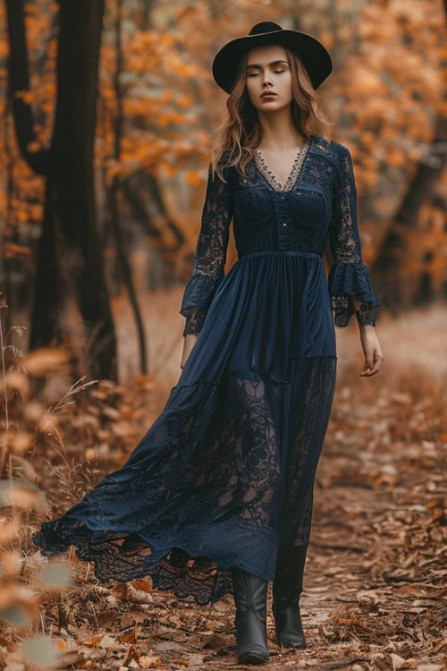 a woman wears a dark blue maxi dress with cowboy boots