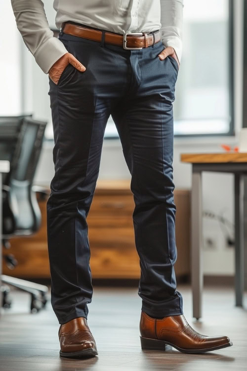 a man wears brown cowboy boots, a shirt and pants