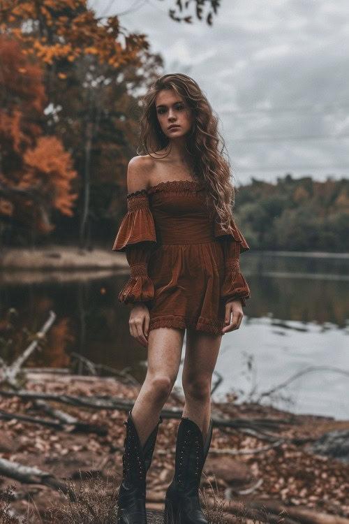 A woman wears a burnt orange ruffled country wedding guest dress with black studded boots