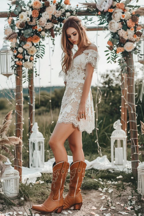 A woman wears a short lace Bridesmaids Dress with Cowboy Boots