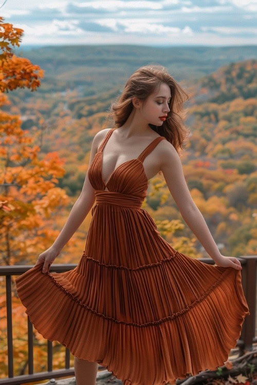 A woman wears a tiered rust-colored wedding guest dress with thin straps