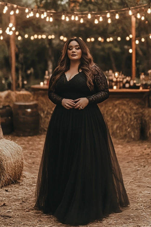 A plus size woman wears a black tulle wedding guest dress with lace sleeves