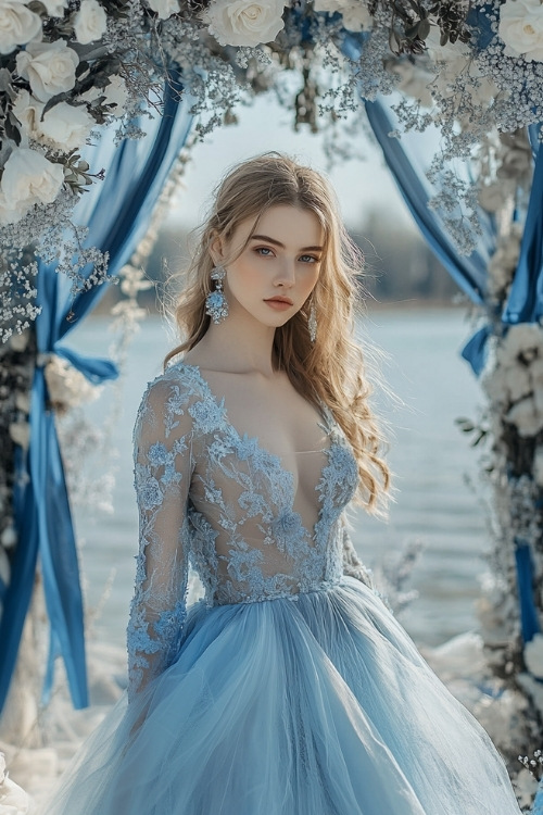 A woman wears a light blue lace wedding guest dress with a deep neckline