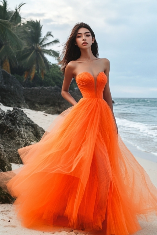 A woman wears a strapless orange tulle wedding guest dress with a voluminous skirt