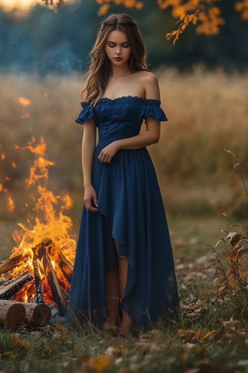 A woman wears an off-the-shoulder navy wedding guest dress with ruffle detailing and a high-low hem