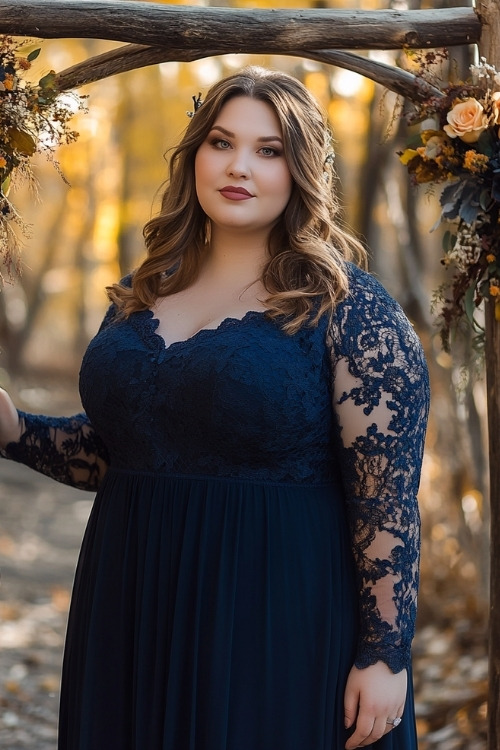 a plus size woman wears a navy lace wedding guest dress with sheer sleeves