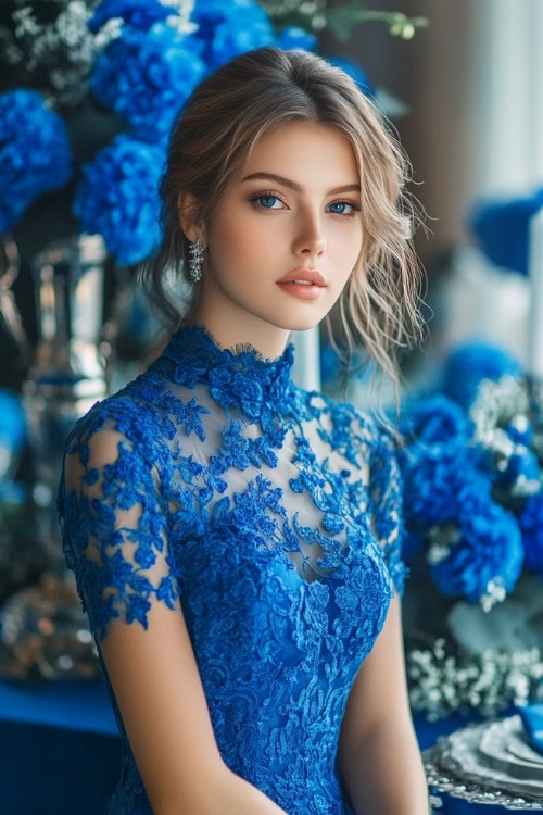 a woman wears a blue lace wedding guest dress with a high neckline