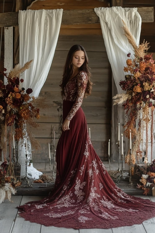 a woman wears a maroon wedding guest dress with lace details