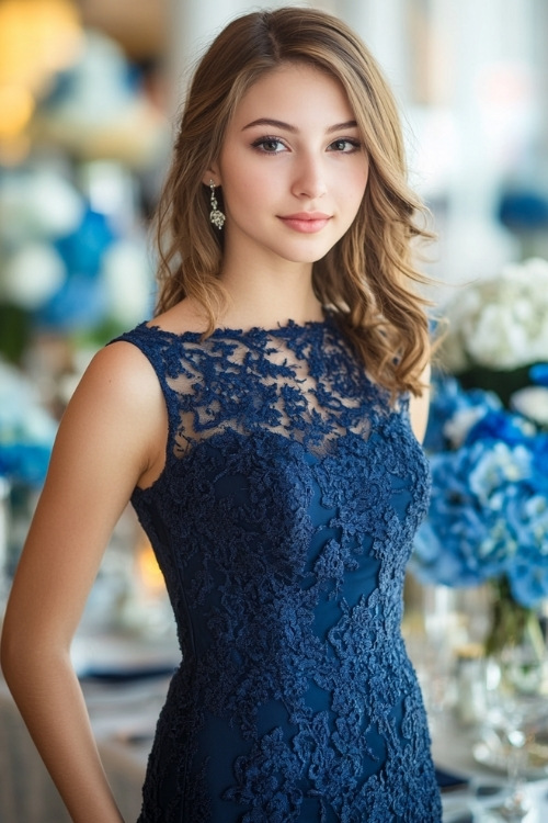 a woman wears a navy blue lace wedding guest dress and a square neckline