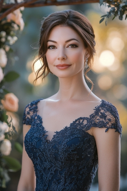 a woman wears a navy blue lace wedding guest dress with short sleeves