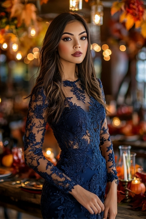 a woman wears a navy lace wedding guest dress with sheer sleeves