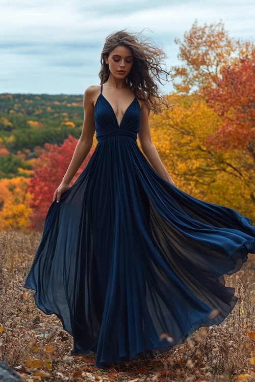 a woman wears a navy wedding guest dress with a flowing skirt