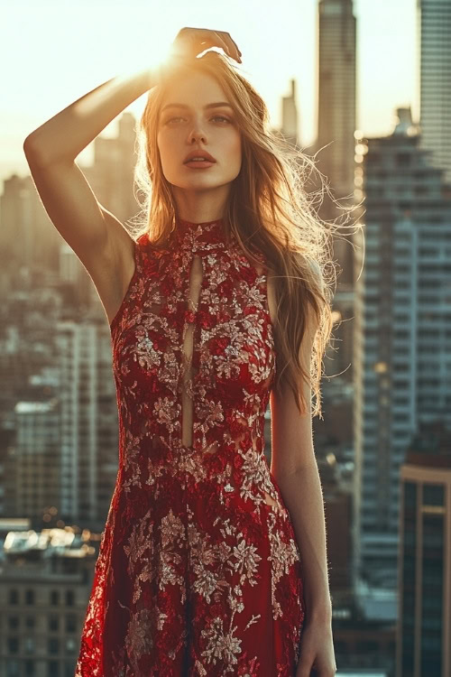 a woman wears a red lace wedding guest dress with gold embroidery