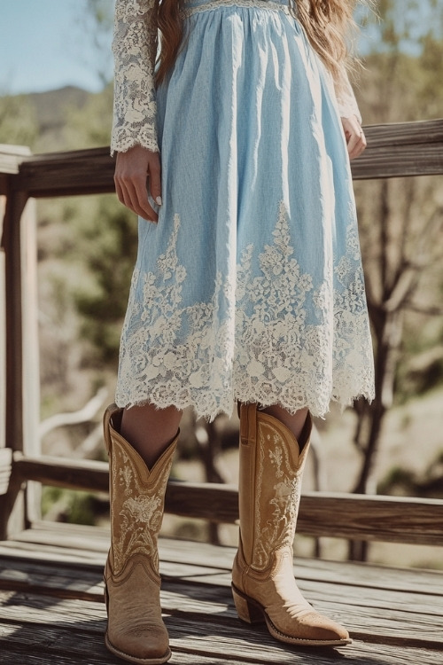 a woman wears a blue lace dress and beige cowboy boots