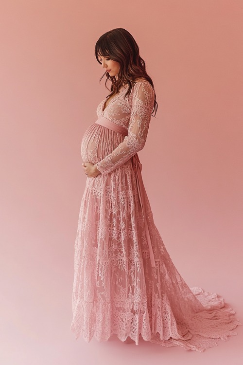 A timeless maternity look with a long-sleeve A-line maternity dress in dusty rose lace, featuring an illusion neckline, cinched waist with a ribbon belt