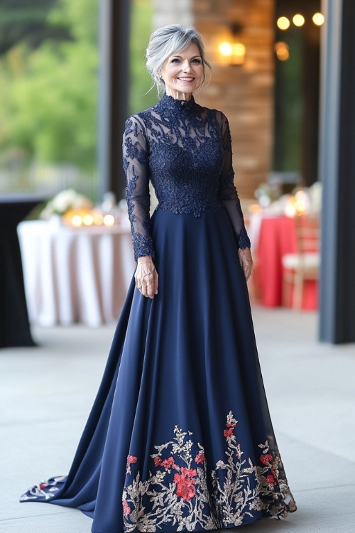 A chic woman over 50 in a navy floor-length A-line dress with a high neckline, lace embroidery, and subtle floral prints