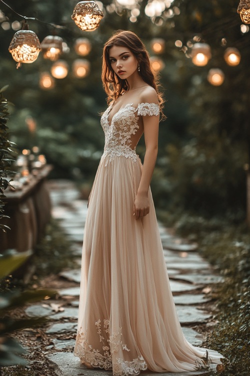 A woman in a champagne-colored tea-length dress with lace cap sleeves and a fitted bodice, standing gracefully by a stone pathway with wedding decorations in the background